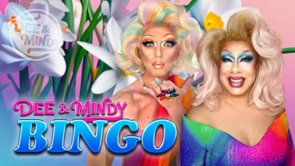 Two Drag Queens in full costume with a flower background.