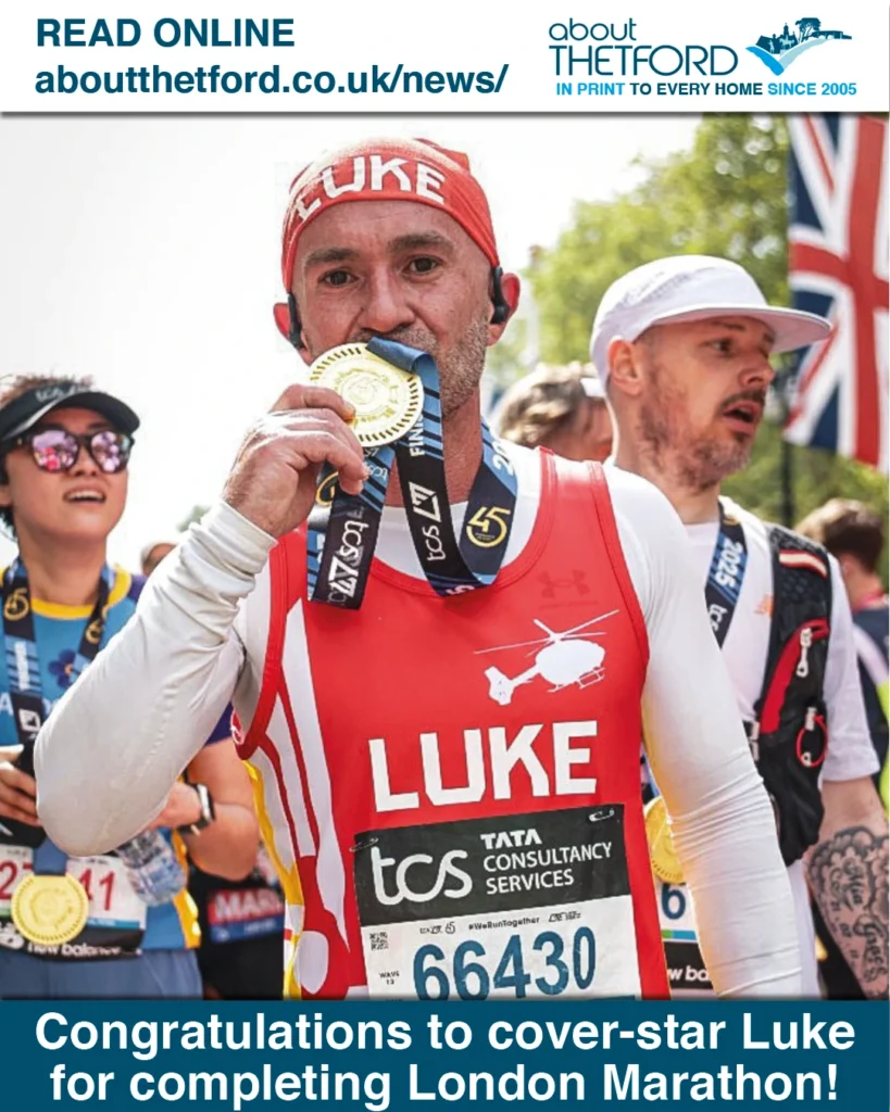 A triumphant runner named Luke holds up his finisher’s medal after completing the London Marathon. He is wearing a red headband with “LUKE” in white letters and a matching red vest that features a white helicopter graphic and the name “LUKE” across the chest. Below that is his race bib number: 66430, and the TCS (Tata Consultancy Services) marathon branding. Behind him, other runners can be seen wearing medals, sunglasses, and celebratory expressions. The top banner reads “READ ONLINE aboutthetford.co.uk/news/” alongside the About Thetford logo. The bottom banner reads: “Congratulations to cover-star Luke for completing London Marathon!”