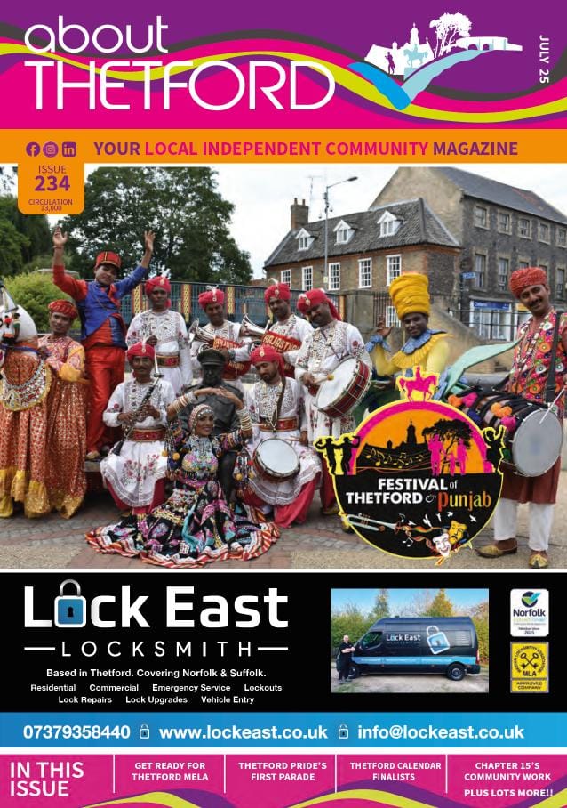 Front cover of About Thetford magazine, Issue 234, July 2025. The header is in vibrant pink, white, and multicolour ribbon design with the magazine’s logo and tagline: “YOUR LOCAL INDEPENDENT COMMUNITY MAGAZINE.” Below the header is a full-width photo showing colourful performers in traditional Rajasthani and Punjabi costumes posing at Thetford’s Capt. Mainwaring statue. They are dressed in red, white, yellow and gold, holding instruments and dancing. A “Festival of Thetford & Punjab” logo overlaps the bottom right of the image, showing silhouettes of dancers, musicians, and Thetford landmarks. The bottom third of the cover features an advert for Lock East Locksmith, with a photo of their black service van, contact details, and icons for Norfolk Trusted Trader and MLA Approved Company. At the bottom is a pink banner listing features in this issue: “Get Ready for Thetford Mela,” “Thetford Pride’s First Parade,” “Thetford Calendar Finalists,” “Chapter 15’s Community Work,” and “PLUS LOTS MORE!!”
