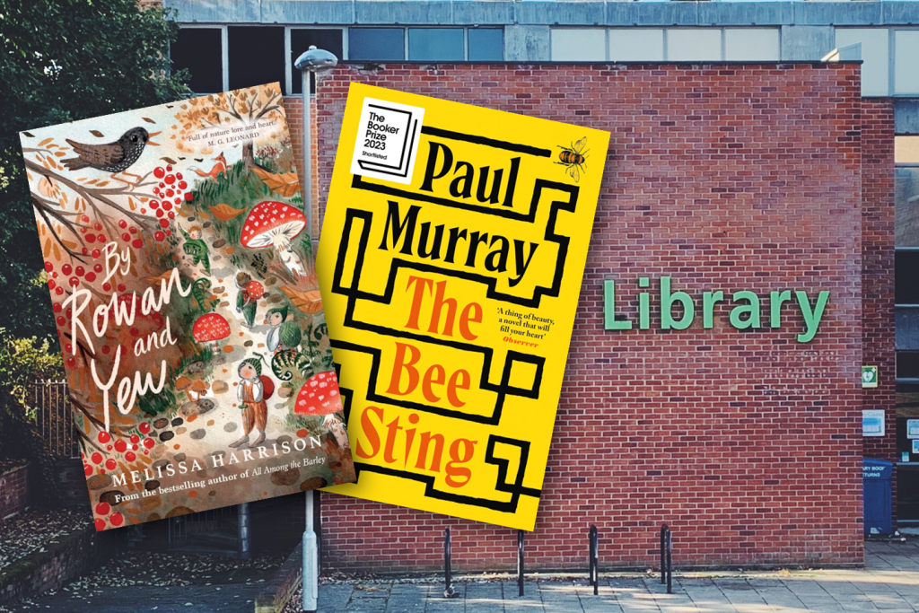 Two book covers overlaid on a photo of a brick library building with a green “Library” sign. The left book is By Rowan and Yew by Melissa Harrison, illustrated with birds, mushrooms, and woodland figures. The right book is The Bee Sting by Paul Murray, with a bold yellow and black design and a small bee illustration.