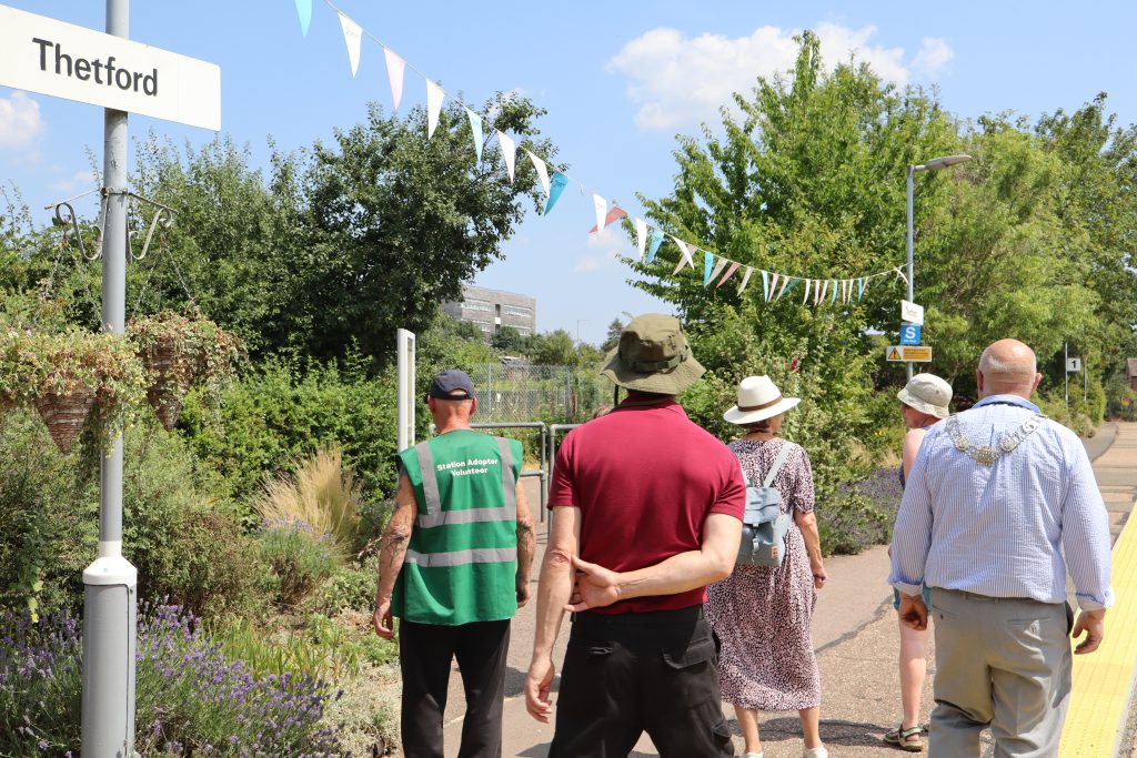 Anglia in Bloom judges and volunteers tour the colourful planted displays at Thetford railway station.
